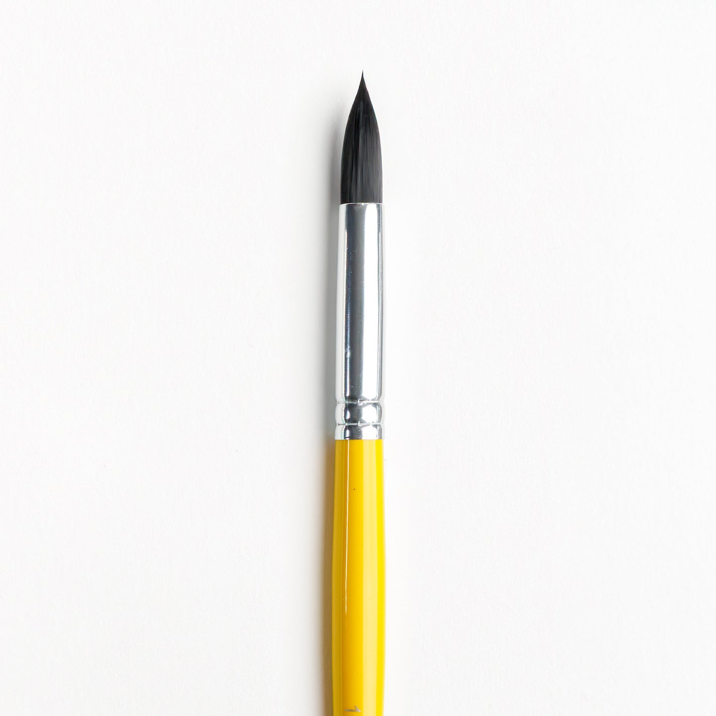 Close up of Size 10 Round brush with dark bristles, silver ferrule, and bright yellow handle