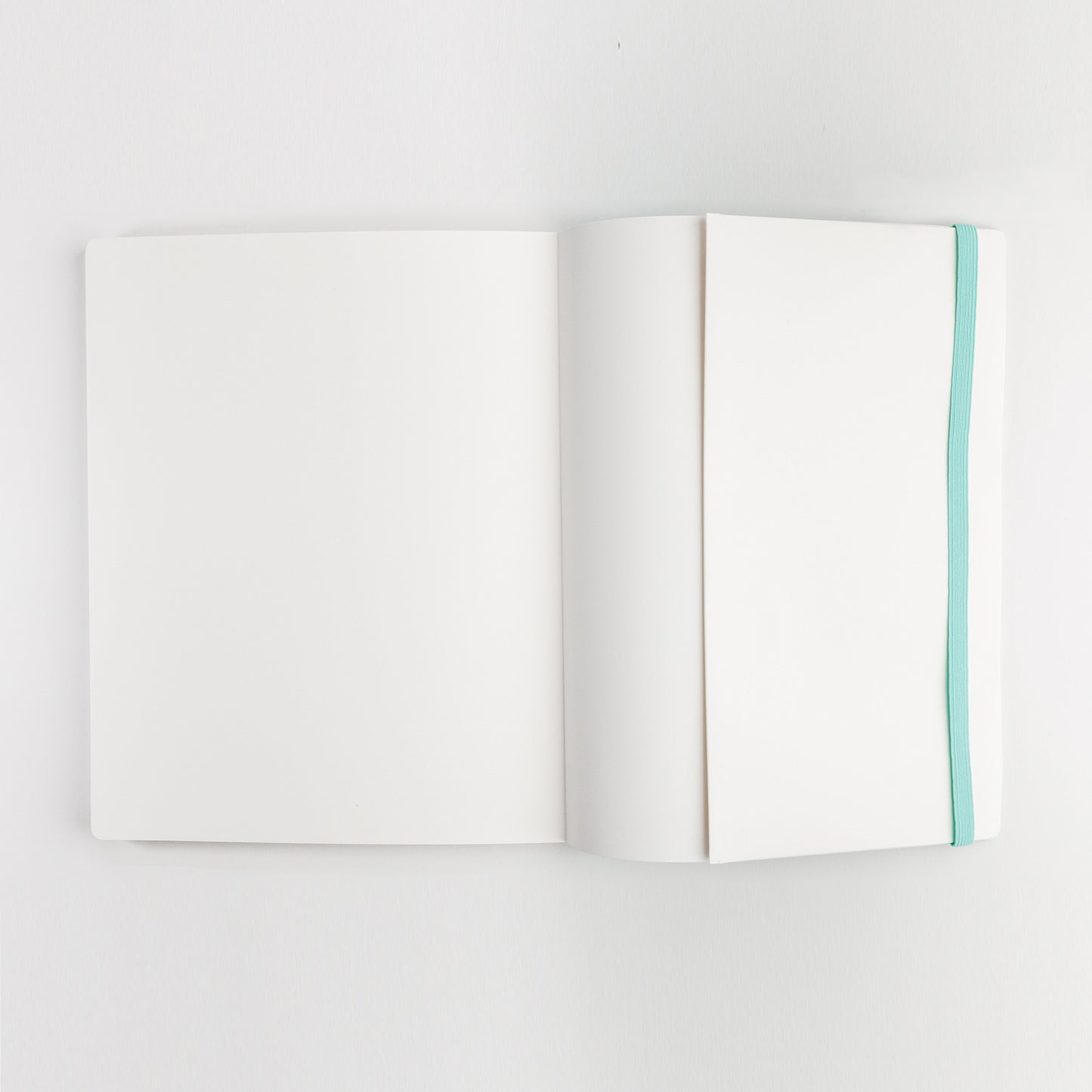 Watercolor practice book open to back cover inside pocket and showing elastic closure band