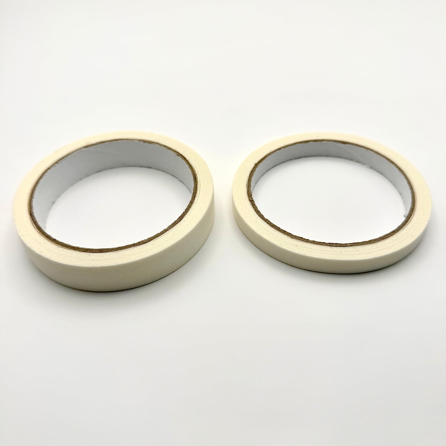 Two rolls of white tape on a white background