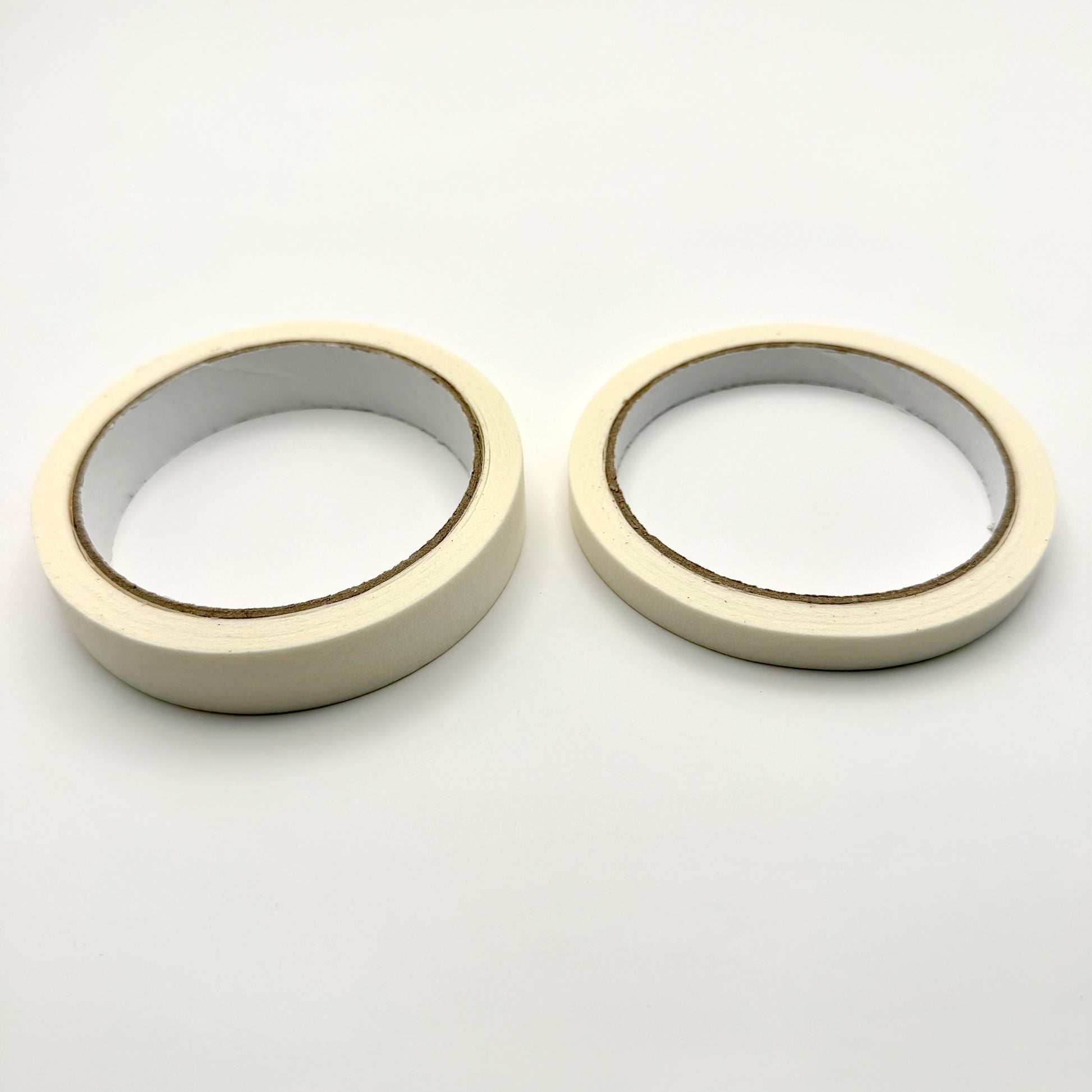 Two rolls of white tape on a white background