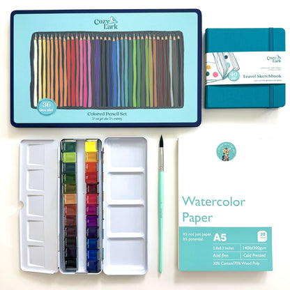 Cozy Lark watercolor painting kit including a 36-color colored pencil set, watercolor paints in a metal tin, a travel sketchbook, A5 watercolor paper, a paintbrush, and a palette, arranged on a white background.