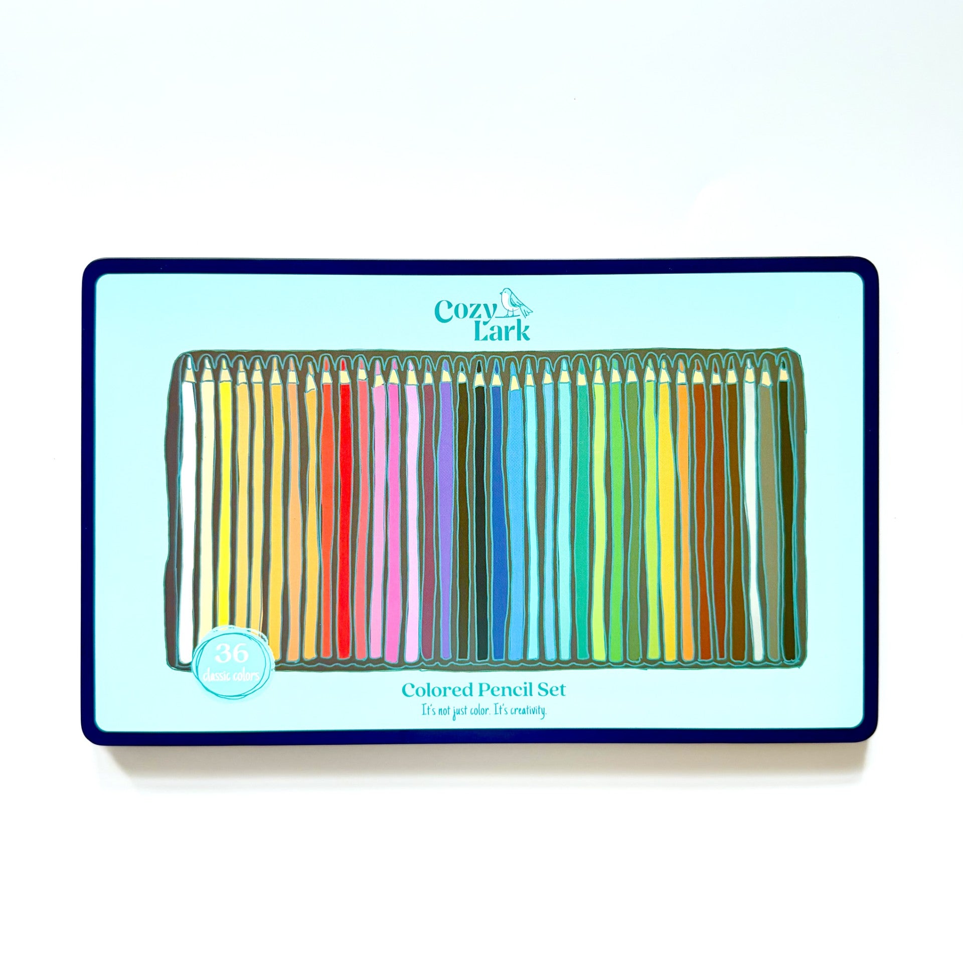 Set of colored pencils in a box with Cozy Lark branding on a white background