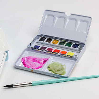 Cozy Lark 12-color watercolor palette with bright paints and a brush on  white background