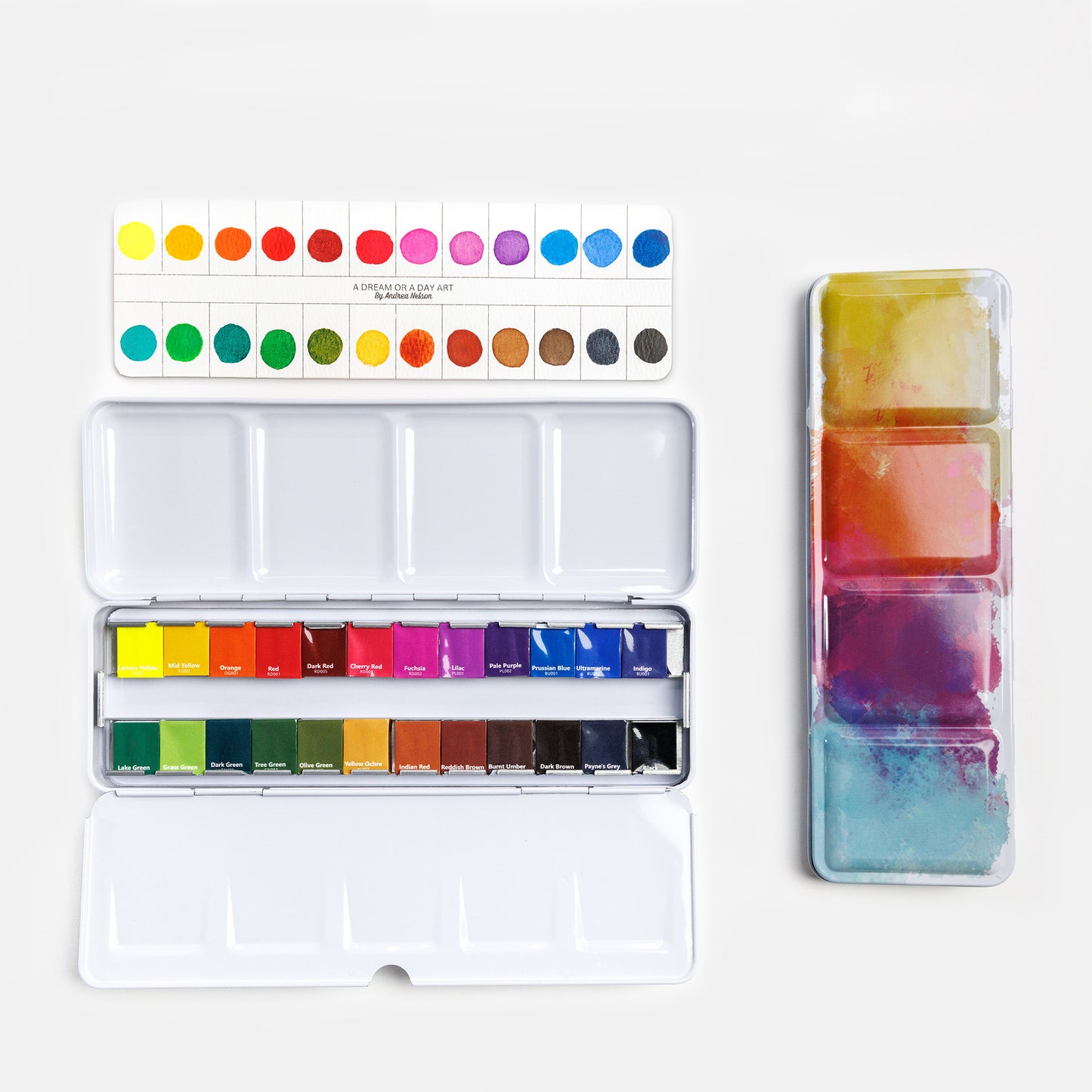 Essential watercolor paint set with 24 colors in open palette with swatch card above and closed tin beside it