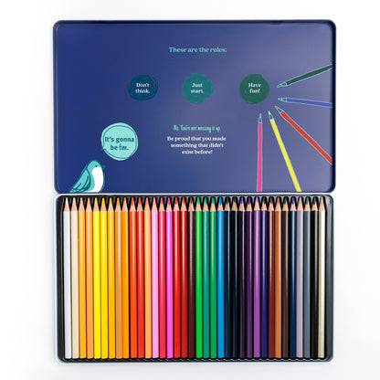 Open set of 36 colored pencils with motivational copy in the inside cover on a white background