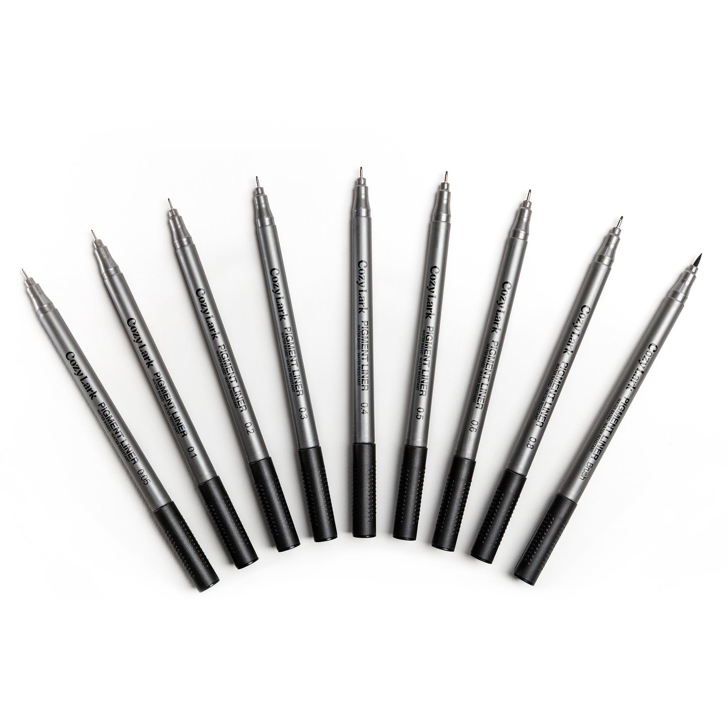 Set of nine gray Cozy Lark pigment liner pens fanned out in an arc on white background
