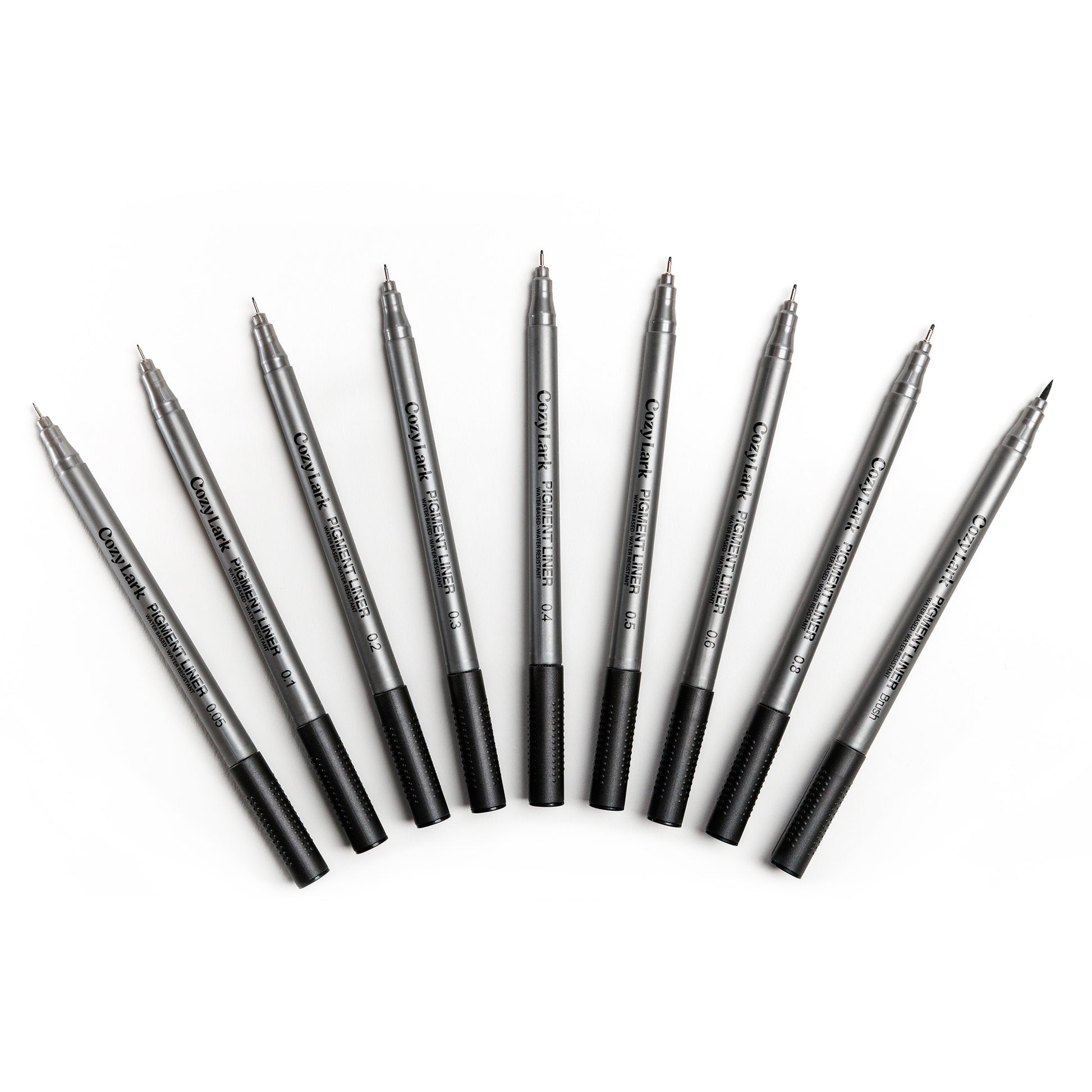 Set of nine gray Cozy Lark pigment liner pens fanned out in an arc on white background