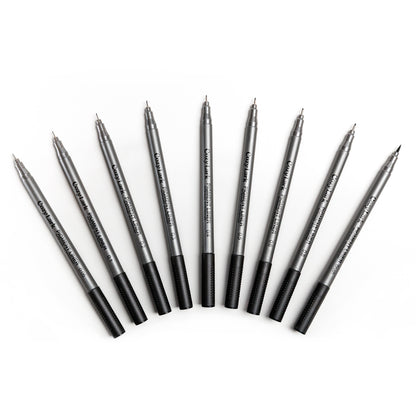 Set of nine gray Cozy Lark pigment liner pens fanned out in an arc on white background