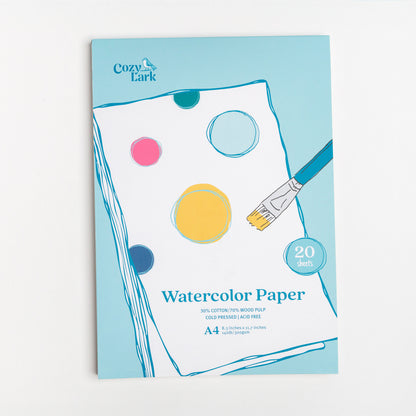 Cozy Lark A4 Watercolor Paper pad with illustrated paint circles and brush on blue cover
