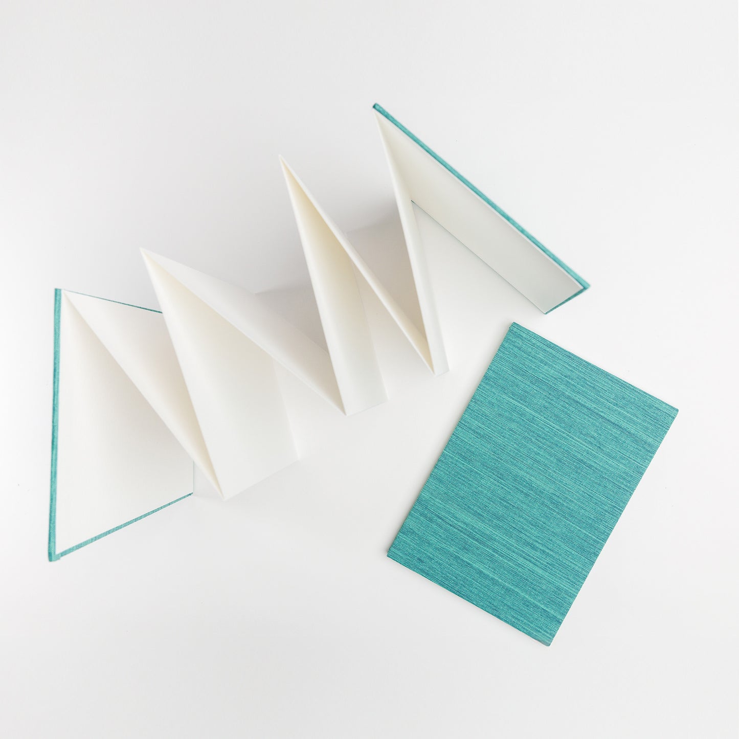 Overhead view of accordion book open and closed