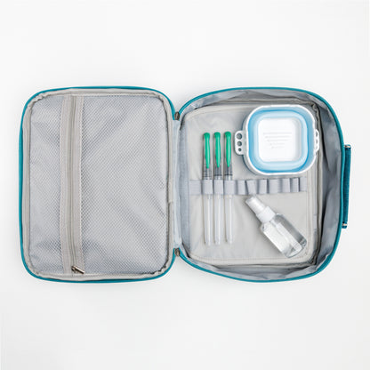 Open teal Cozy Lark travel case showing mesh pocket, three water brushes, collapsible water cup, and refillable spray bottle organized inside