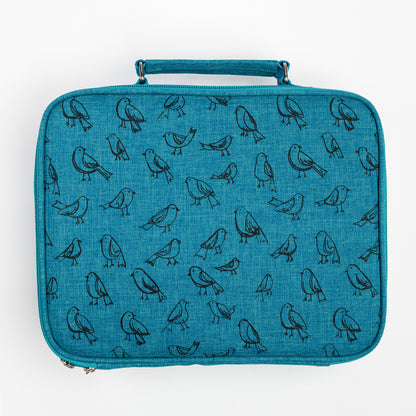 Teal Cozy Lark travel art case with black bird illustrations and handle on top against white background