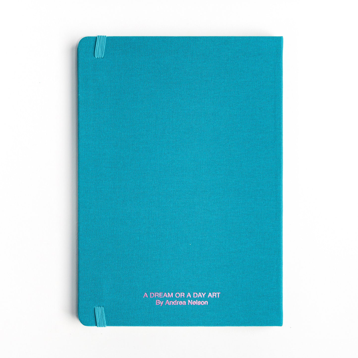 Back cover of watercolor hardcover sketchbook showing pink metallic "A Dream or A Day" imprint 