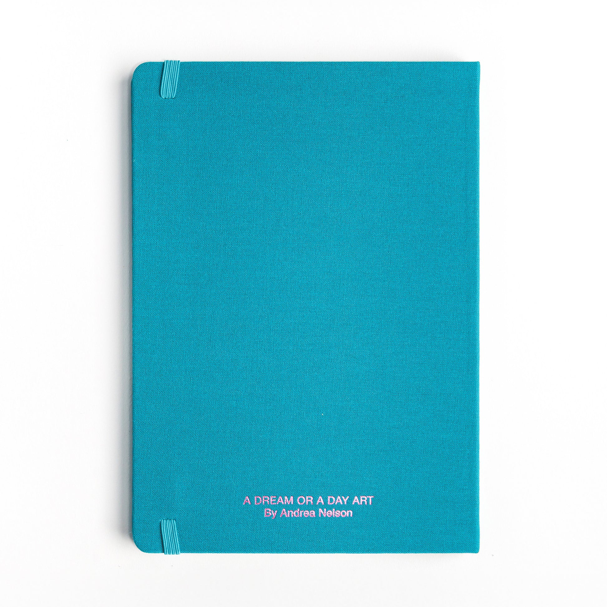 Back cover of watercolor hardcover sketchbook showing pink metallic "A Dream or A Day" imprint 