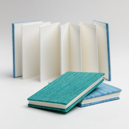 Open accordion book in background with set of two accordion mini books stacked in the foreground