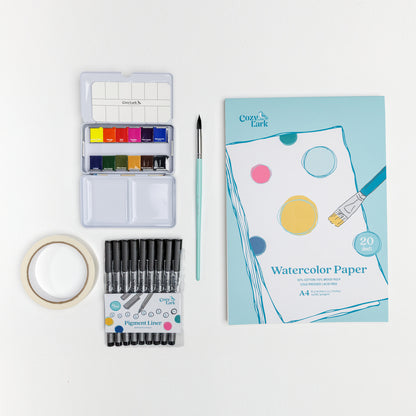 Flat lay of Cozy Lark starter bundle with mini watercolor palette, mint brush, masking tape, pigment liner set, and A4 watercolor paper pad on white background