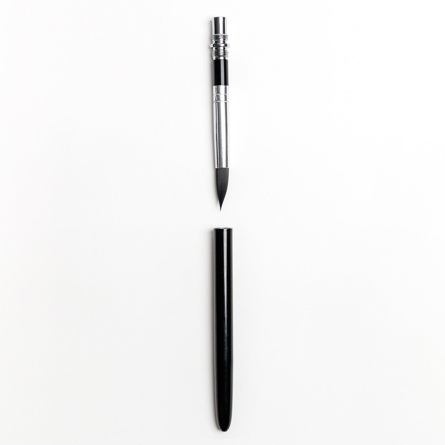 Compact travel watercolor brush with detachable black handle separated 