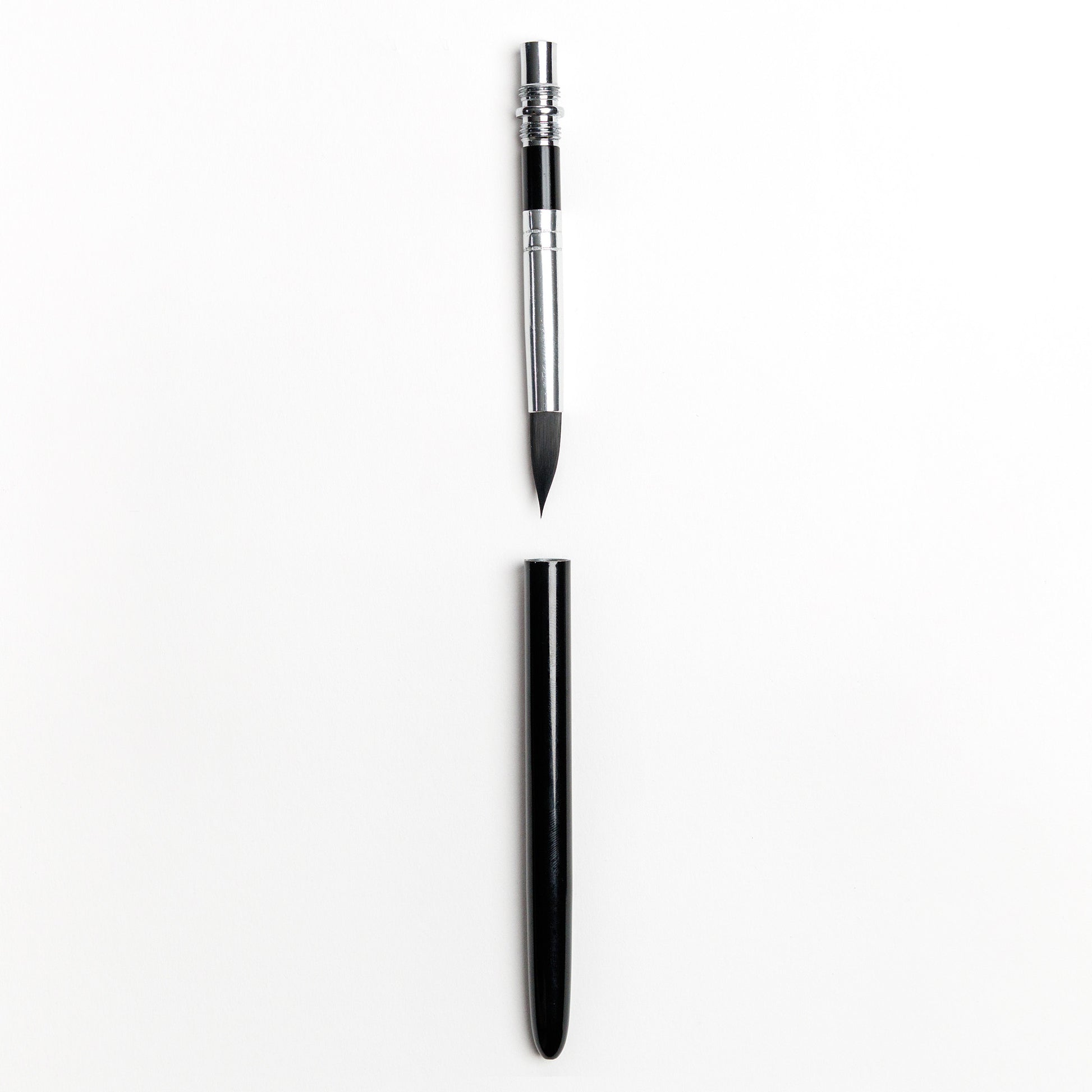 Compact travel watercolor brush with detachable black handle separated 