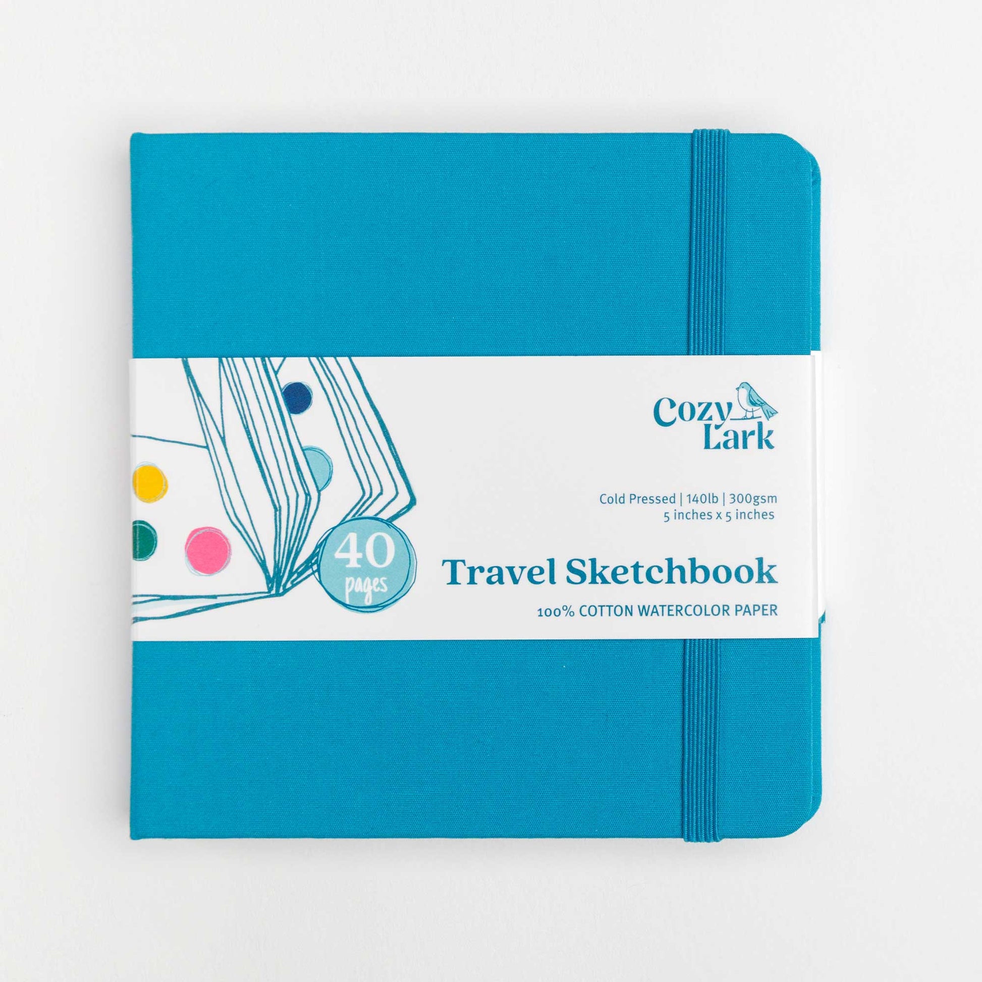 Front view of a Teal cloth hard cover Travel Sketchbook with elastic closure and Cozy Lark branded belly band on a white background.