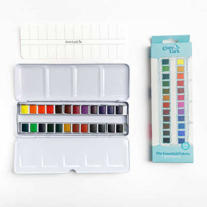 24-color Watercolor paint set with open palette, swatch card and packaging on a white background.