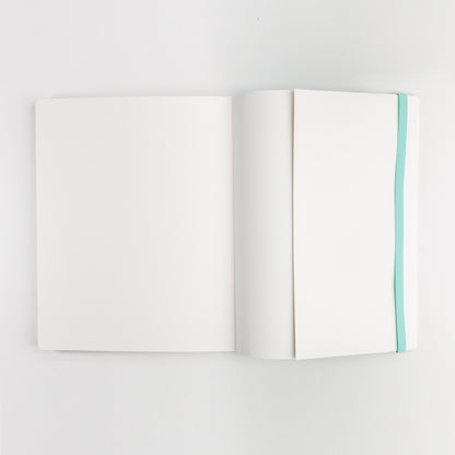 Watercolor practice book open to back cover inside pocket and showing elastic closure band