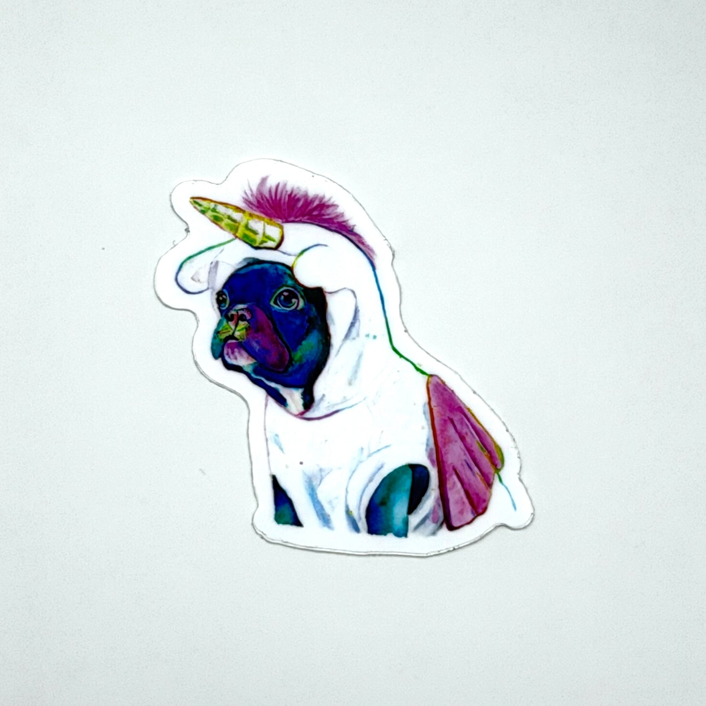 Sticker of a colorful Frenchie dog wearing a unicorn costume on a white background